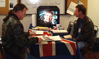 Bill Ward & Rick Van Norstrom view Video Visits and plow through the yearbooks.